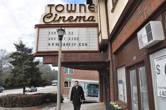 Fisher Paty, with Oakhurst Realty Partners, stands beneath the marquee at Towne Cinema. Photo by: Dan Whisenhunt