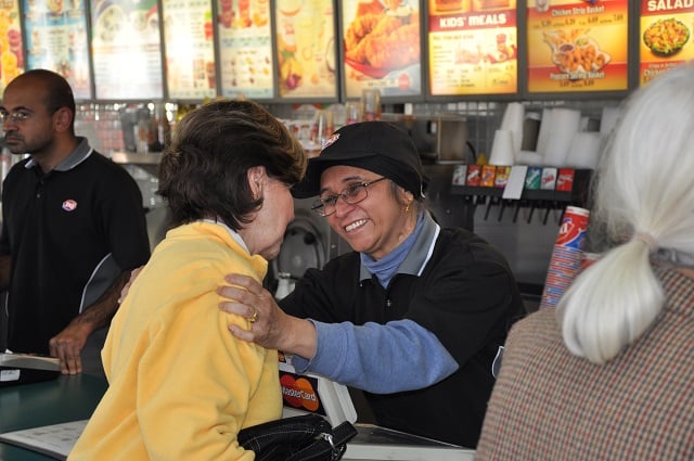 Nadera Momin, a member of the family that owns the Decatur Dairy Queen, talks to long time customer Colline Broom on Feb. 17. Photo by: Dan Whisenhunt