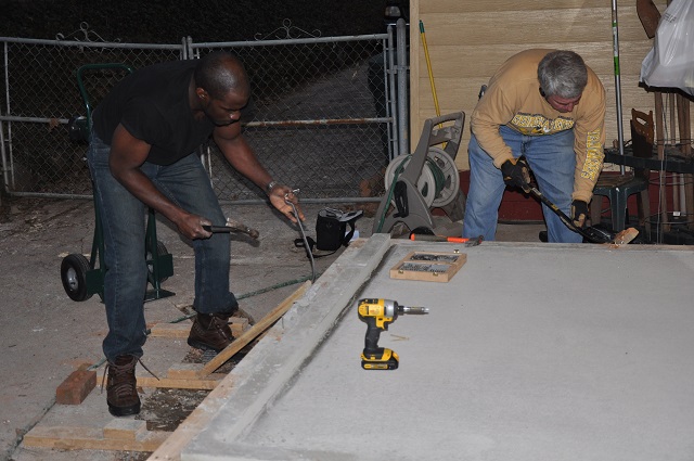 Ron Crane, left and Mark Sanders, right, finish up a handicap ramp for Crane's grandmother, Julia Smith, on Feb. 18. It's one of the last projects from the MLK Service Project in Decatur. 