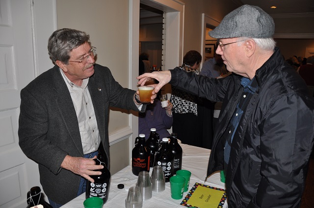 Avondale Estates City Commissioner John Quinn serves up a tasty beverage at the Taste of Avondale event, held Feb. 15.