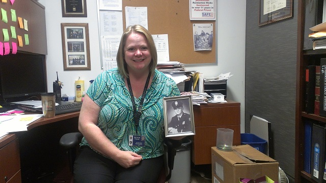 Decatur Police Sgt. Jennifer Ross, holding a picture of her father. Photo by: Dan Whisenhunt