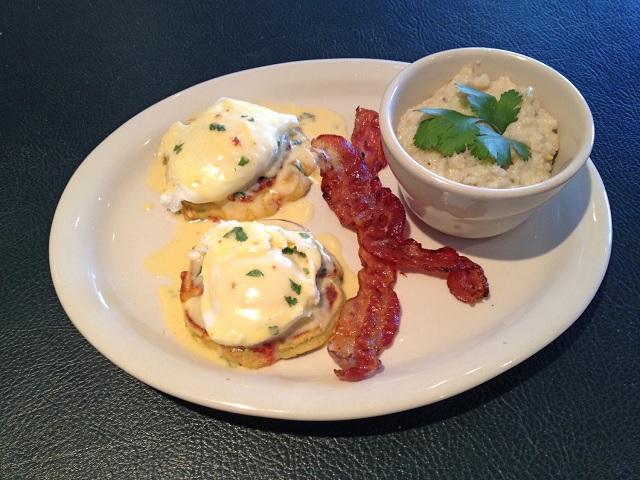 A menu item from the relaunched Crescent Moon Sunday brunch: Corncakes with poached eggs and chipotle hollandaise with sides of bacon and Green Chile Grits. Photo courtesy of: Taqueria El Vecino