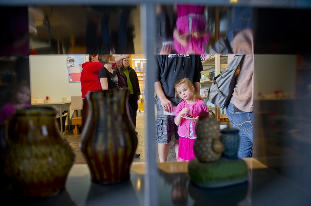 Photo: Jonathan Phillips Kaydence Spangler (right) looks at some of the pottery at MudFire Pottery Gallery as she walks around with her family during the Rail Arts District's Art Cruise on Saturday, March 15, 2014.