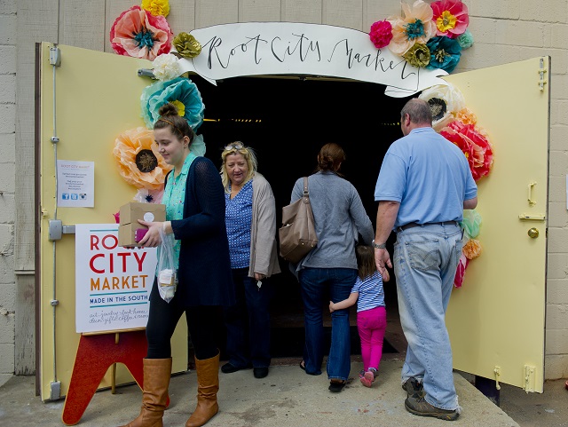 Photo: Jonathan Phillips Emsley Brems (left) and her mother Liz leave Root City Market in Avondale Estates with packages of artwork during the Rail Arts District's Art Cruise on Saturday, March 15, 2014.
