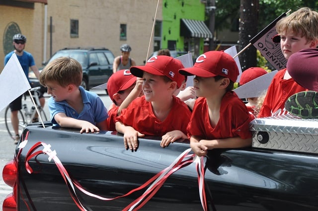 Players in Decatur's youth baseball league greet spectators during a parade on Saturday, June 7. Photo by Dan Whisenhunt