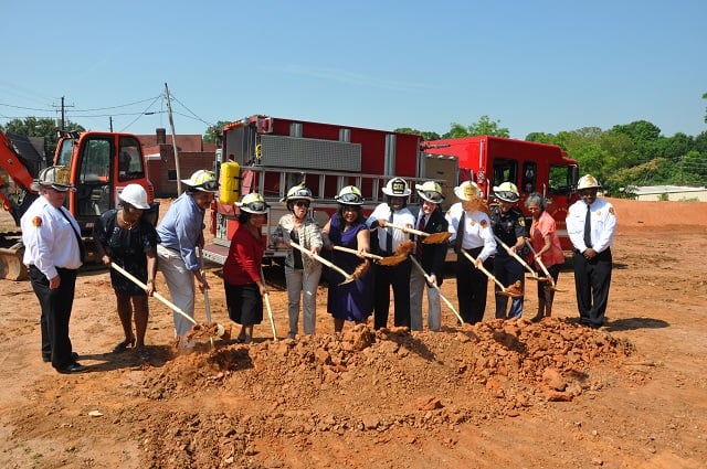 Avondale Estates and DeKalb County officials shovel some dirt to mark the groundbreaking of the new fire station in Avondale Estates. Photo by Dan Whisenhunt