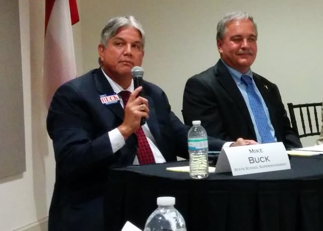 Mike Buck, left, and Richard Woods, right, at a June 30 candidates forum. Photo by Dan Whisenhunt