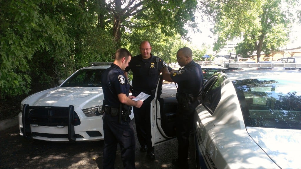 Decatur Police Officers compare notes in the parking lot of Decatur High. File photo by Dan Whisenhunt