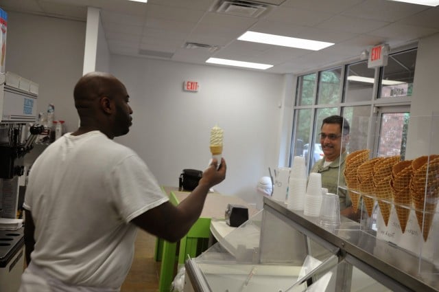 Dolphin Coley, left, hands Tomas Vallejo an ice cream cone. Photo by Dan Whisehunt