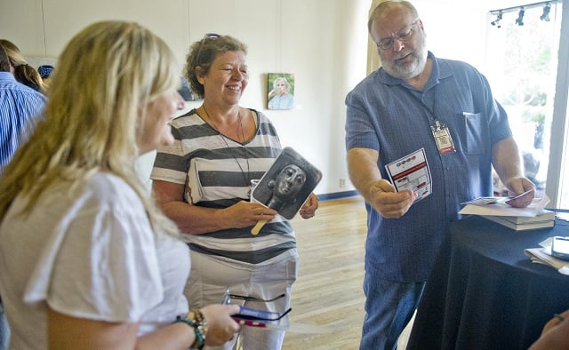Photo: Jonathan Phillips  Raymond Atkins (right), his wife Marsha and Cat Blanco talk inside the hospitality suite during the AJC Decatur Book Festival on Saturday, August 30, 2014. The ninth annual event saw tens of thousands of people come out to the downtown Decatur area to meet with world-class authors, illustrators, editors, publishers, booksellers, and artists for a weekend filled with literature, music, food, art, and fun.