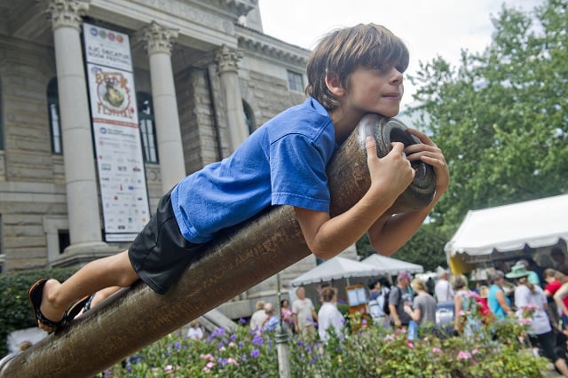 File Photo: Jonathan Phillips  Diogo Richards hangs out on the barrel of the cannon outside of the historic courthouse during the AJC Decatur Book Festival on Saturday, August 30, 2014. The ninth annual event saw tens of thousands of people come out to the downtown Decatur area to meet with world-class authors, illustrators, editors, publishers, booksellers, and artists for a weekend filled with literature, music, food, art, and fun. /File Photo