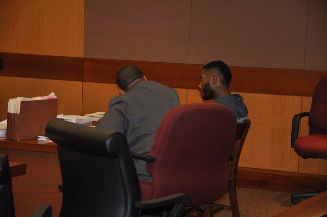 Joseph Alan Lewis, right, speaks with his attorney Overton Thierry, left, during an Aug. 1 preliminary hearing. Photo by Dan whisenhunt
