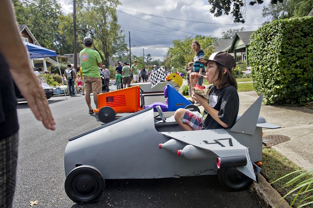 Photo: Jonathan Phillips Jack Kelly takes a bite of ice cream as he sits in his car made to look like a fighter jet from the movie Top Gun before the start of the 4th annual Madison Ave. Soap Box Derby in Decatur on Saturday, September 27, 2014.