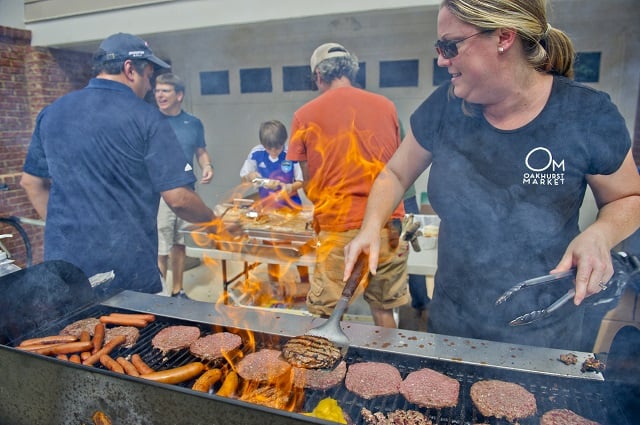 Photo: Jonathan Phillips Harriet Berry flips burgers on the grill before the start of the 4th annual Madison Ave. Soap Box Derby in Decatur on Saturday, September 27, 2014.