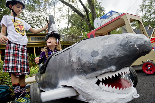 Photo: Jonathan Phillips Jacob Donald (left) puts a shark fin helmet on Penelope Netherton's head as she sits in a fellow racers vehicle before the start of the 4th annual Madison Ave. Soap Box Derby in Decatur on Saturday, September 27, 2014.