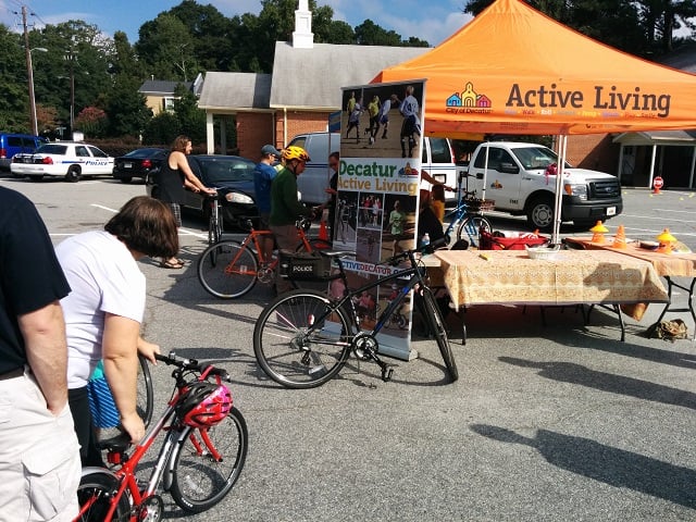 Kids and parents lined up at the Decatur Active Living tent to register their bikes. Photo by Dan Whisenhunt