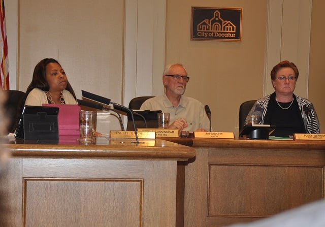 Left to right: Commissioner Kecia Cunningham, Mayor Jim Baskett and City Manager Peggy Merriss listen to a presentation during the Sept. 2 City Commission meeting. File Photo by Dan Whisenhunt