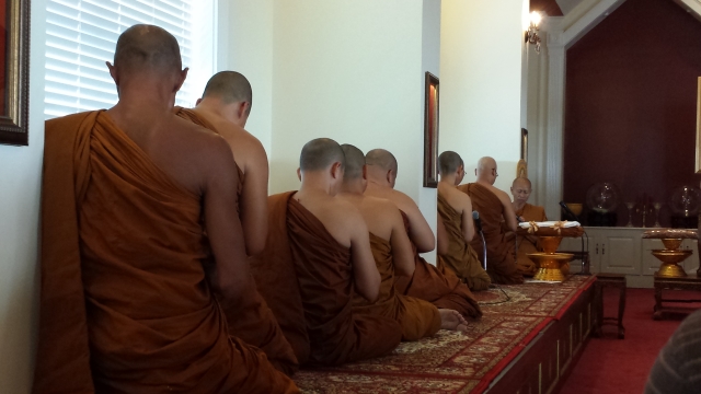 Buddhist monks sit in the temple during the Kathina ceremony. Photo by Dena Mellick