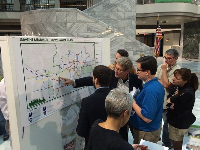 Attendees study proposals for improving the Memorial Drive corridor. Photo by By Kim Hutcherson