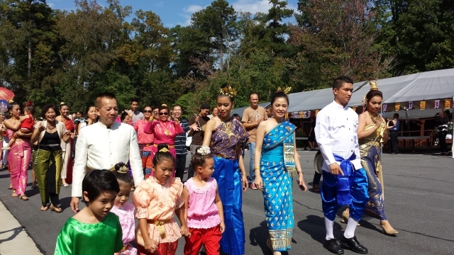 Jom Sichanthalath (right of photo, with blue pants) leads a parade of lay supporters around the temple. Photo by Dena Mellick