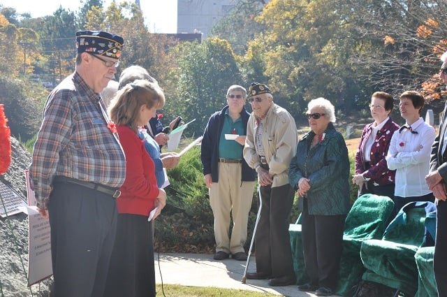 A veteran struggles to stand during a Veterans Day ceremony at the Decatur Cemetery on Nov. 11, 2014 - File Photo by Dan Whisenhunt