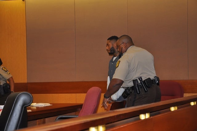 Joseph Alan Lewis is escorted by a bailiff during an Aug. 1 hearing in Fulton County Superior Court. Photo by Dan Whisenhunt