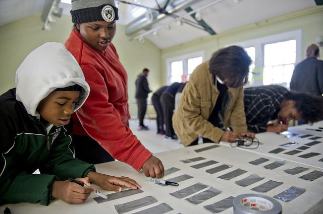 Christopher Lewis (left), Tasalinah Andralliski, Tiana Lewis and Teaheerah Andralliski make nametags before heading out to volunteer during the Decatur Martin Luther King Jr. Service Project weekend on Sunday, January 18, 2015. Photo by Jonathan Phillips