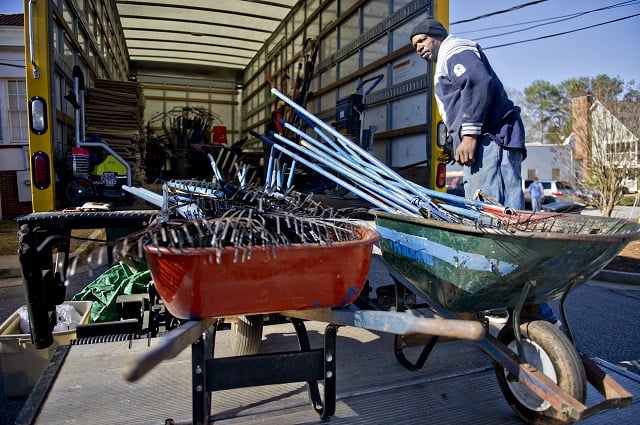 Ronnie Williams unloads wheelbarrows full of tools that will be used to make repairs during the Decatur Martin Luther King Jr. Service Project weekend on Sunday, January 18, 2015.  Photo by Jonathan Phillips
