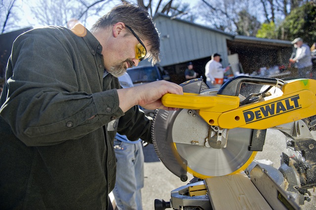 Quinn Eastman uses a saw to cut a piece of wood during the Decatur Martin Luther King Jr. Service Project weekend on Sunday, January 18, 2015.  Photo by Jonathan Phillips