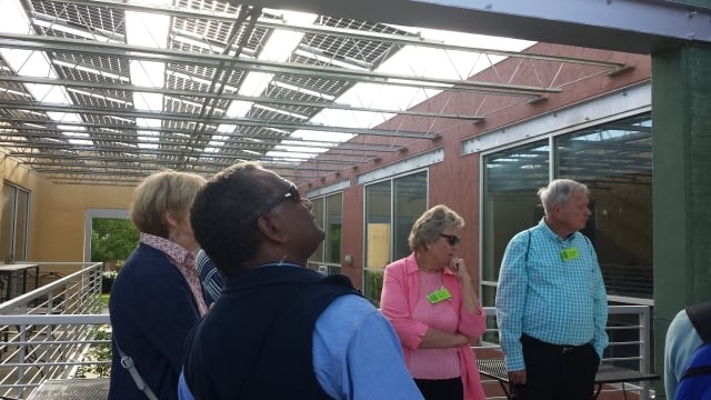 Cliff Bird, a conference attendee from Fiji, looks up at the solar panels at East Decatur Station during a tour that was part of the 2015 Caring for Creation conference. Photo by Dena Mellick