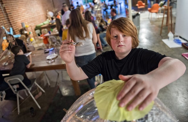 Photo: Jonathan Phillips Renny Hyde (right) creates a U.F.O. shaped lantern during a workshop at Color Wheel Studio in Decatur on Friday, April 24, 2015. 12 workshops will be held before the Decatur Lantern Parade on May 15.