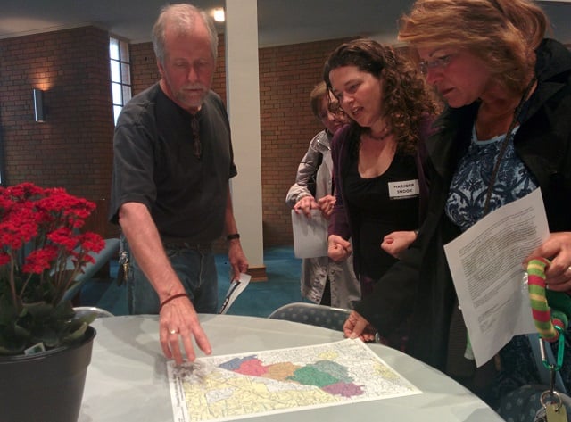 Left to right: Peter Noonan, DeKalb Strong President Marjorie Snook, and Robin Lee Fitch look over maps for the proposed cities of Tucker and LaVista Hills during a voter information meeting held on April 16. Photo by Dan Whisenhunt