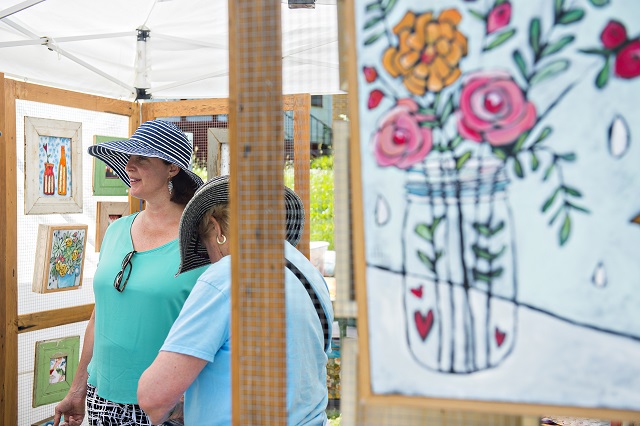 Susan Darcy Fuller (left) and her mother Nancy Darcy look at the artwork in Jenni Horne's booth during the Kirkwood Spring Fling. Photo: Jonathan Phillips