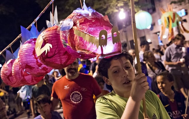 Ian Hogben (right) carries a dragon lantern with his brother Alec during the Decatur Lantern Parade. Photo: Jonathan Phillips