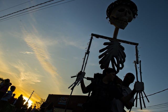 Tim Marker (right) helps his son Coleman with his skeleton lantern before the start of the Decatur Lantern Parade. Photo: Jonathan Phillips