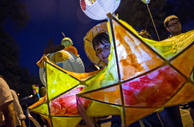 Luke Beckham carries star lanterns during the Decatur Lantern Parade.  Photo: Jonathan Phillips