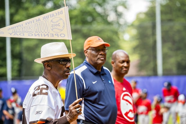 Clarence Scott (left), Harry Flourny and Mike Glenn, all former pro athletes, participate in the ceremony for the opening day of Decatur Youth Baseball at Oakhurst Park. Photo: Jonathan Phillips