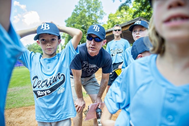 Coach Brett Duke (center0 talks to his team as the ceremony for the opening day of Decatur Youth Baseball comes to a close at Oakhurst Park. Photo: Jonathan Phillips