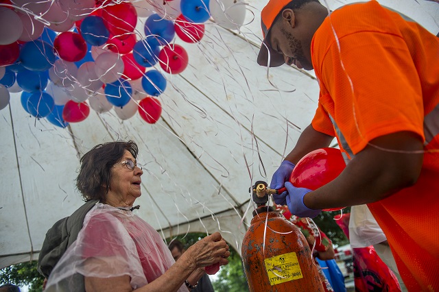 Mary Galpin (left) and Oscar Griffin blow up balloons before the start of the Avondale Estates 4th of July Parade on Saturday, July 4, 2015.  Photo: Jonathan Phillips