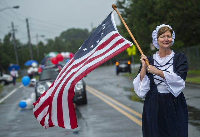 Betsy Ross marches down Clarendon Ave. in the pouring rain during the Avondale Estates 4th of July Parade on Saturday, July 4, 2015.  Photo: Jonathan Phillips