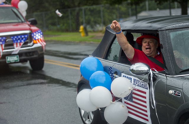 Grand Marshall DOn Connelly throws candy as he rides down Clarendon Ave. during the Avondale Estates 4th of July Parade on Saturday. Photo: Jonathan Phillips