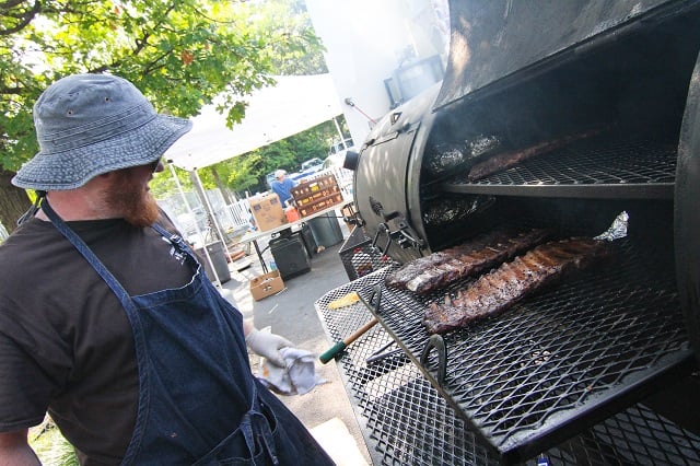 Sweet Auburn Barbecue general manager Joseph Stallings says they have served more than 70 slabs of ribs, 300 pounds of pork and 150 pounds of chicken at the Decatur BBQ, Blues & Bluegrass Festival. Photo by Travis Hudgons/Decaturish.com