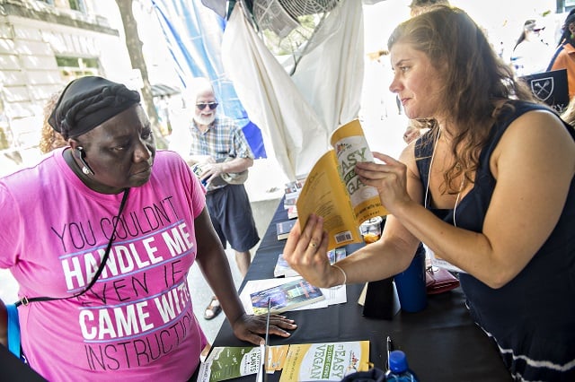Joyce Farmer - Brown (left) checks out Rebecca Gilbert's book It's Easy to Start Eating Vegan during the Decatur Book Festival on Saturday. Photo: Jonathan Phillips