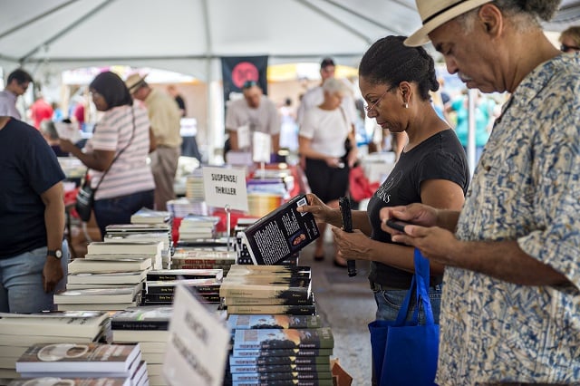 Linda McLoud (center) looks for books to buy in one of the numerous tents at the Decatur Book Festival on Saturday. Photo: Jonathan Phillips