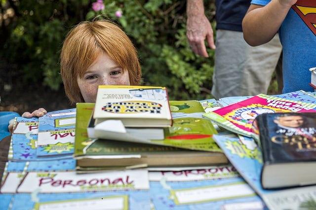 Scott Butterfield gets eye level with some books during the Decatur Book Festival on Saturday. Photo: Jonathan Phillips