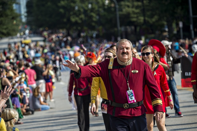 Dressed as Scotty from the Star Trek series and movies, Larry Robertson gives the Vulcan live long and prosper symbol as he marches down Peachtree St. in Atlanta during the annual DragonCon Parade on Saturday. Photo: Jonathan Phillips