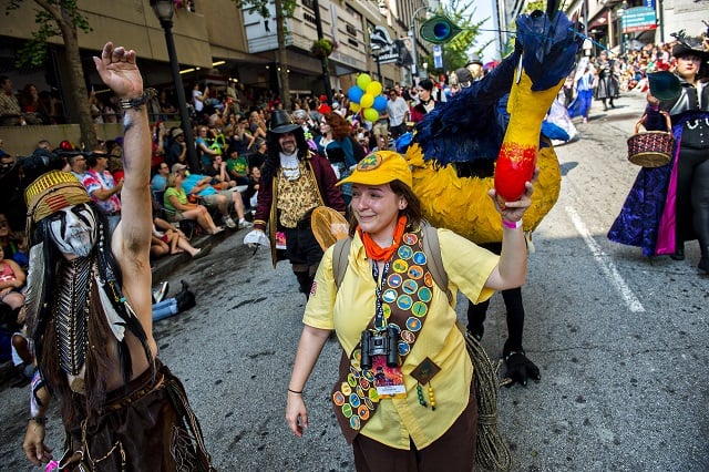 Dressed as characters from the movie UP, Meaghan Brayton (center) leads her sister Brittany down the street during the annual DragonCon Parade in Atlanta on Saturday. Photo: Jonathan Phillips