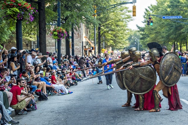 Spartans from the movie 300 play with the crowd as they make their way down Peachtree St. in Atlanta during the annual DragonCon Parade on Saturday. Photo: Jonathan Phillips