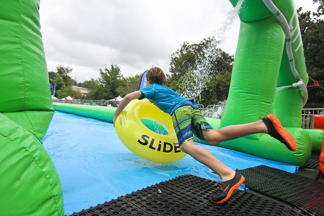 Owen Moorfield takes a big leap onto the slide. Photo by Travis Hudgons