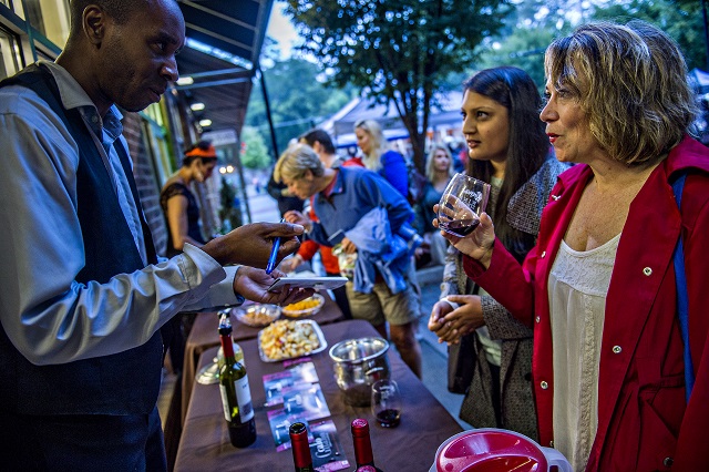 Kevin Wilson (left) marks off the iwne that Priya Desai and Donna Janney try during the Kirkwood Wine Stroll on Friday. Photo: Jonathan Phillips